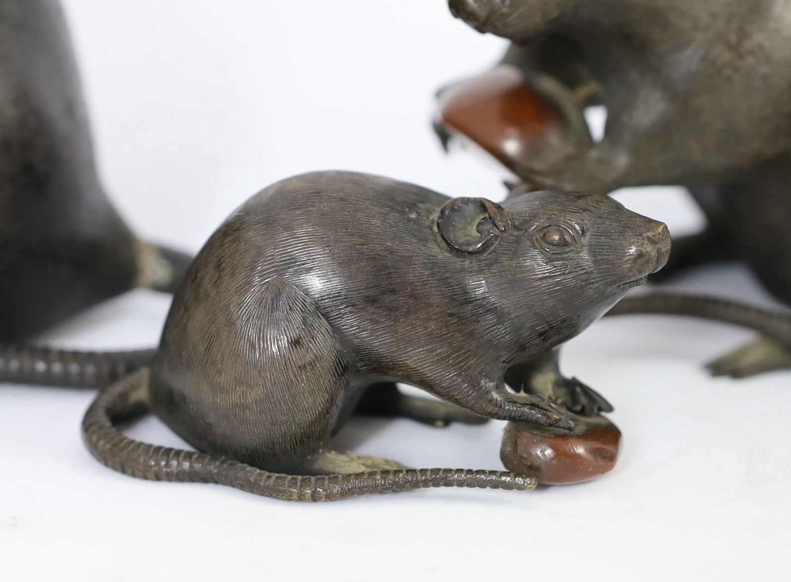 An assembled group of five Japanese bronze and mixed metal models of rats, Meiji period, smallest 9.5cm long, largest 16.5cm long, one small rat tail detached